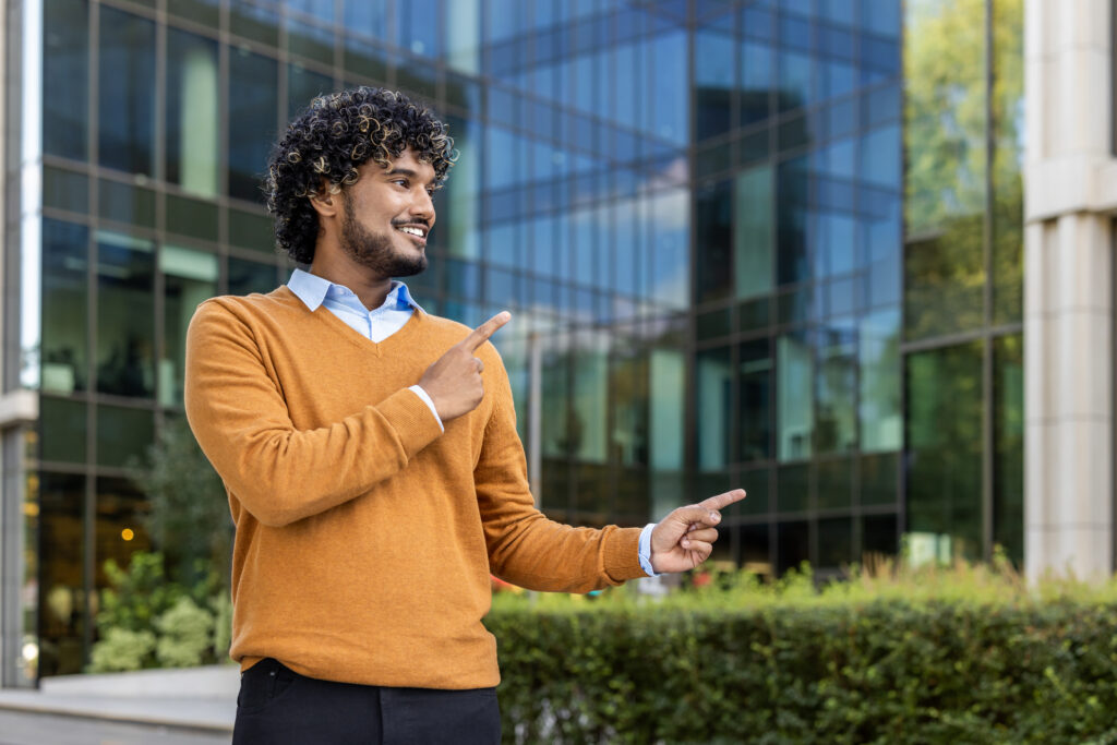 A marketing summer intern pointing outside